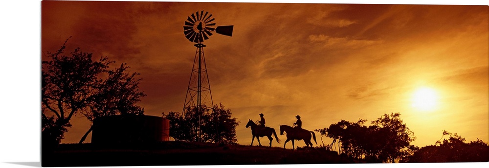 Landscape, panoramic artwork of a hill with a windmill perched at the top on a farm at twilight.