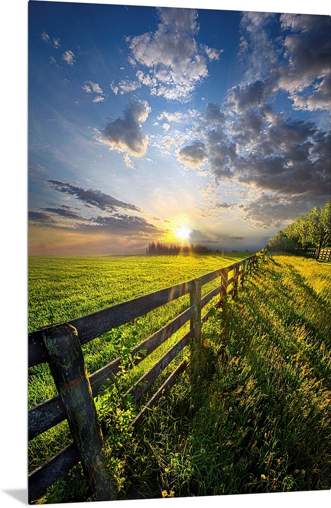 Sunlight and dramatic clouds over a fence in farmland, Wisconsin.