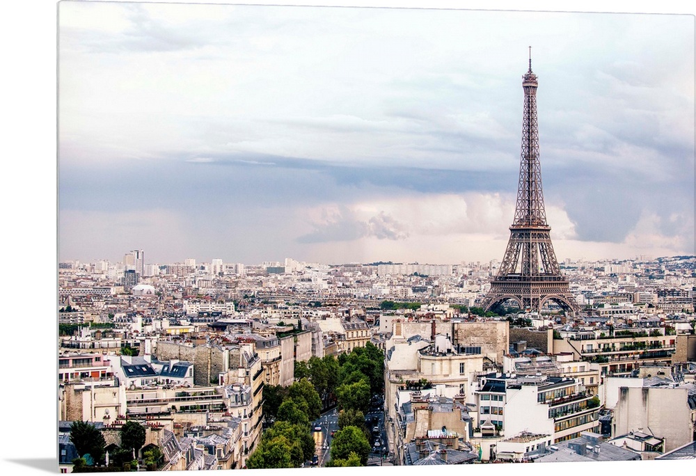 Aerial photograph of a Paris cityscape with the Eiffel Tower towering over all the buildings.