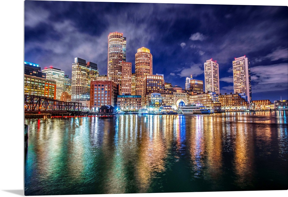The lights of downtown Boston reflect upon Massachusetts Bay.
