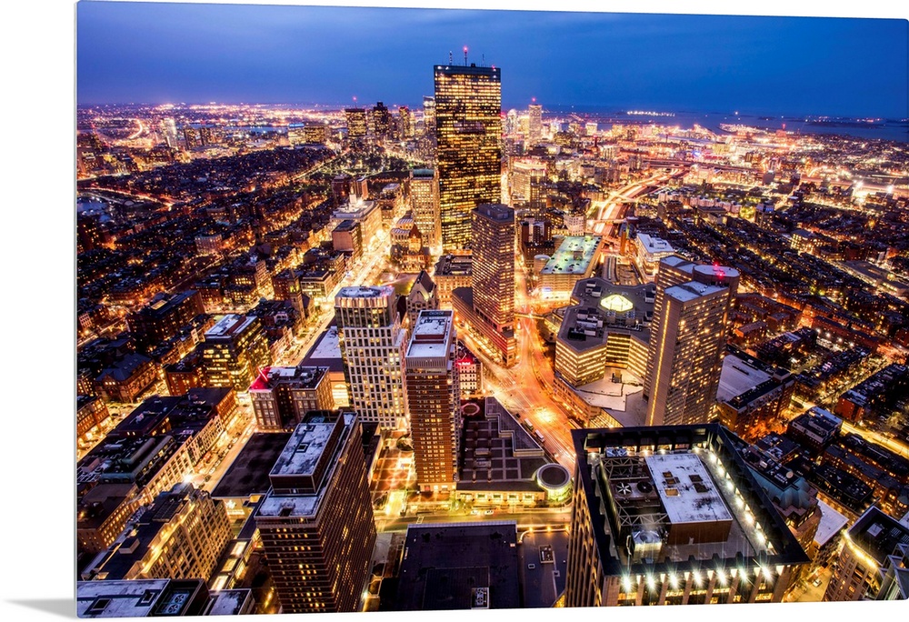 Aerial view of the city of Boston, Massachusetts, lit up at night.