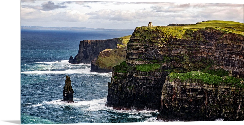 Panoramic photograph of the Cliffs of Moher with O'Brien's Tower seen in the distance, marking the highest point of the Cl...