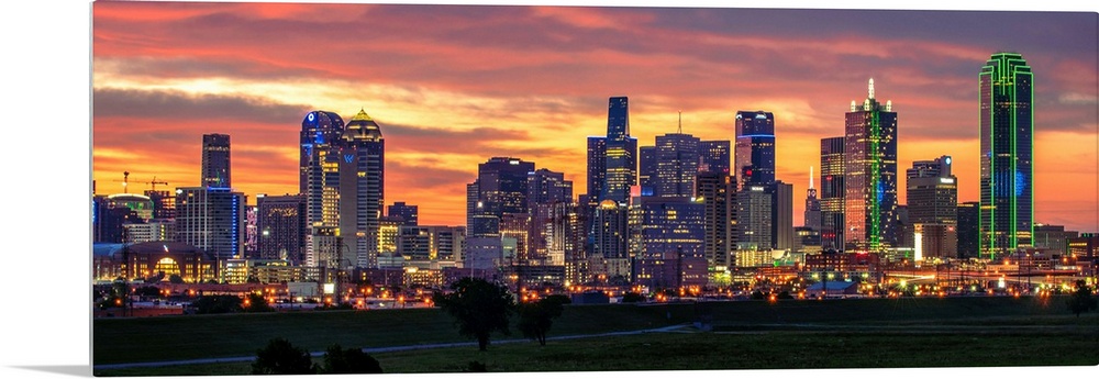 A horizontal image of the Dallas, Texas city skyline with a brilliant sunset.