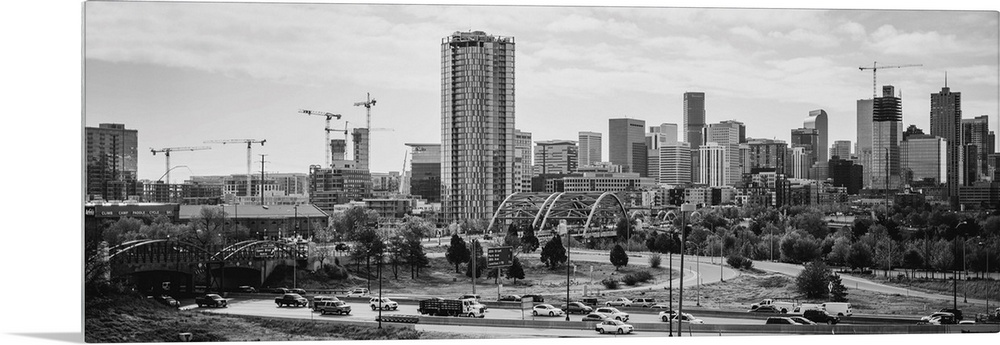 Photograph of the Denver, Colorado skyline with cloudy skies above.