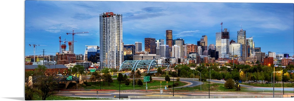Photo of a Denver's skyline with light trails.
