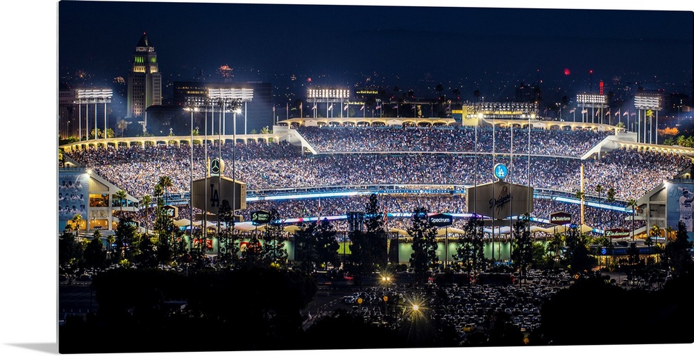 Panoramic photograph of Dodger Stadium lit up on a game night.