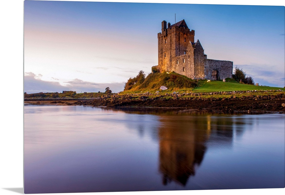 Landscape photograph of the Dunguaire Castle reflecting into the water on the southeastern shore of Galway Bay in County G...