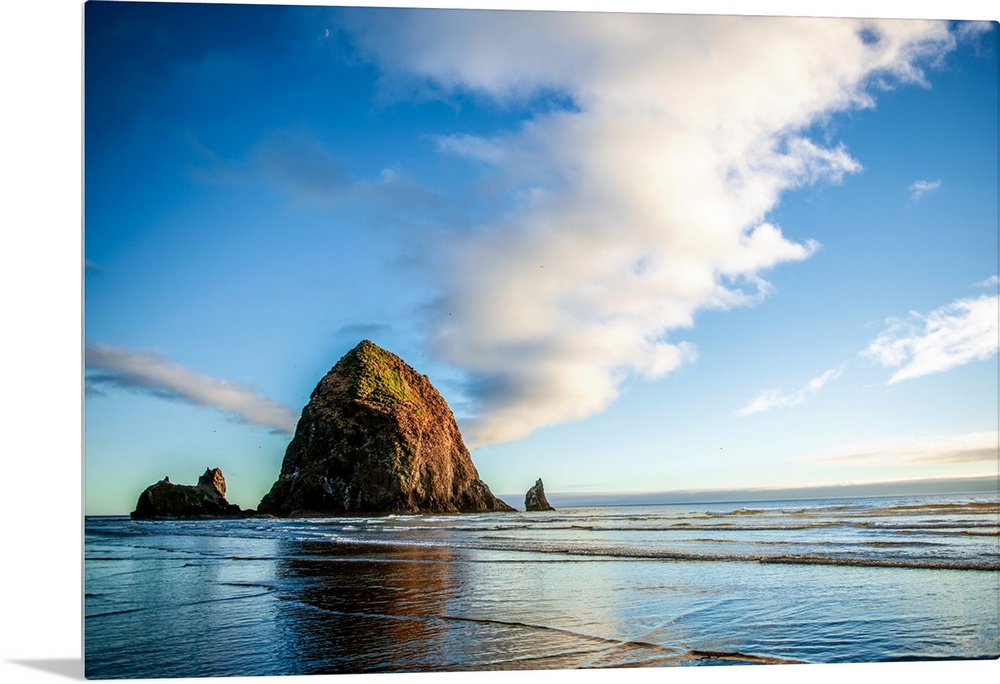 Panoramic photograph of Haystack Rock at golden hour, just before sunset, Cannon Beach, Oregon.