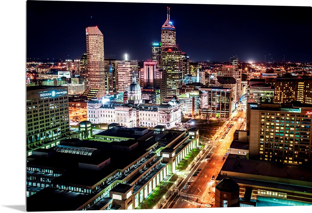 Skyscrapers illuminated at night with busy streets in Indianapolis, Indiana.