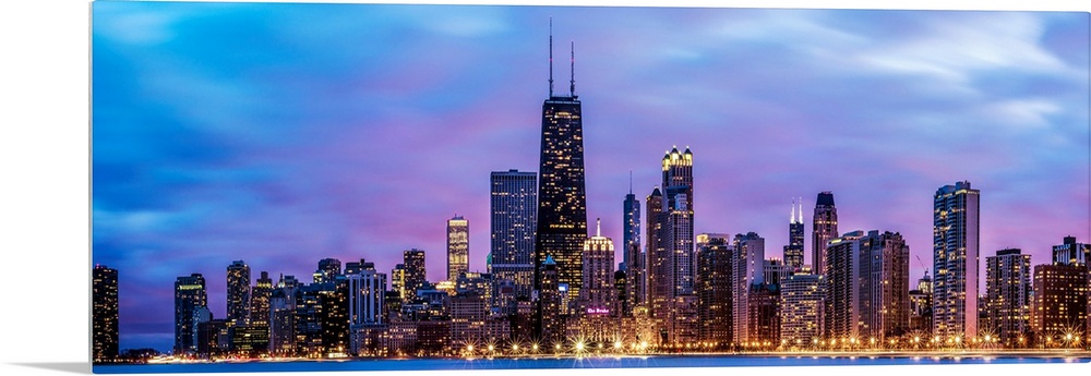 Photo of Chicago skyline at night under cotton candy colored clouds.