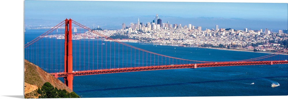 Panoramic photograph of the Golden Gate Bridge with San Francisco's skyscrapers in the background.