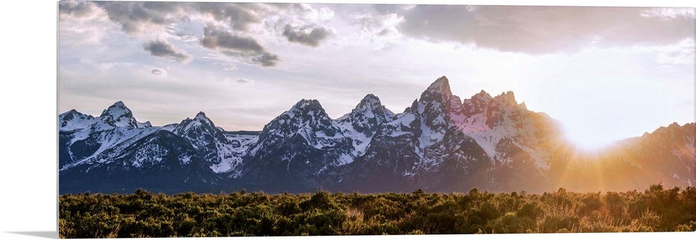 Panoramic view of the sun rising over Teton mountains in Wyoming.