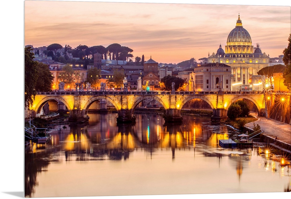 A view of St. Peter's Basilica in the Vatican and the Ponte Sant'Angelo  spanning across the river Tober in Rome, Italy at...