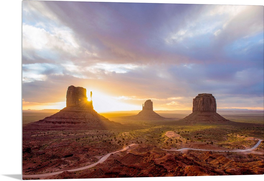 Sunrise at the Mittens and Merrick Buttes in Monument Valley, Arizona.