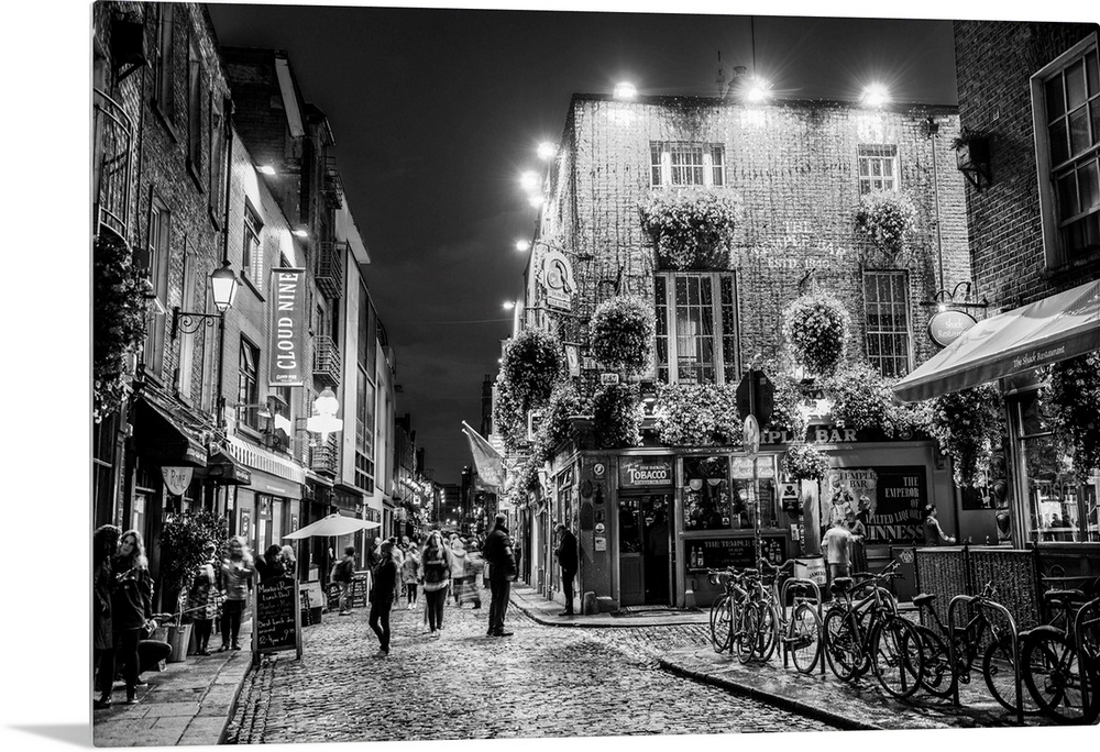 Photograph of Temple Bar, a busy riverside neighborhood in Dublin, Ireland, at night.