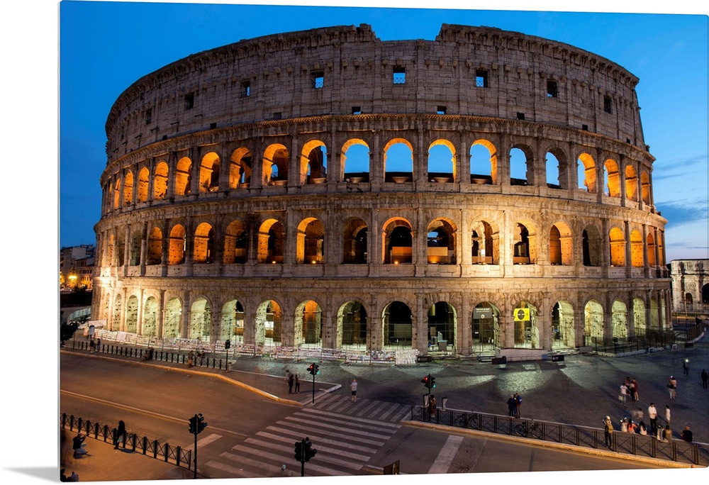 Photograph of the Colosseum lit up at dusk.
