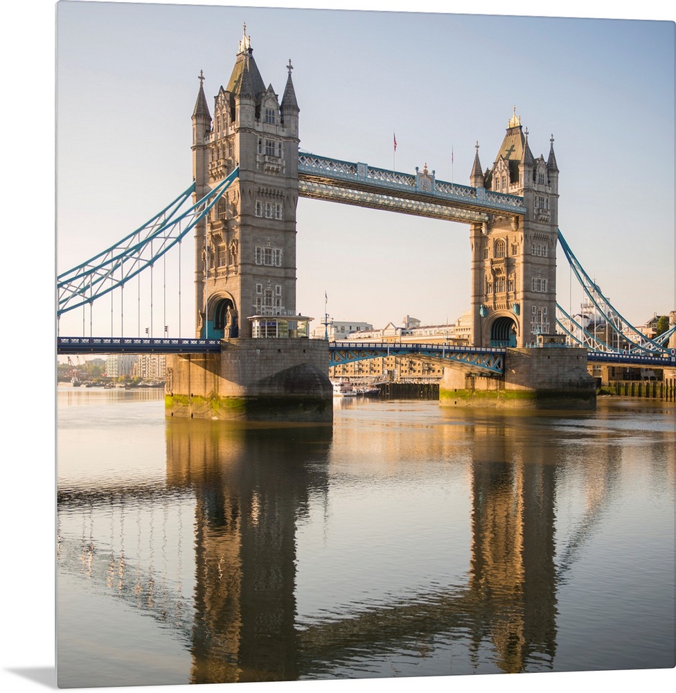 Square photograph of Tower Bridge reflecting into the River Thames in London, England, UK.