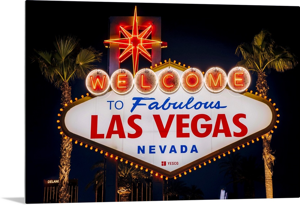 The famous "Welcome to Las Vegas, Nevada" sign is lit at night.