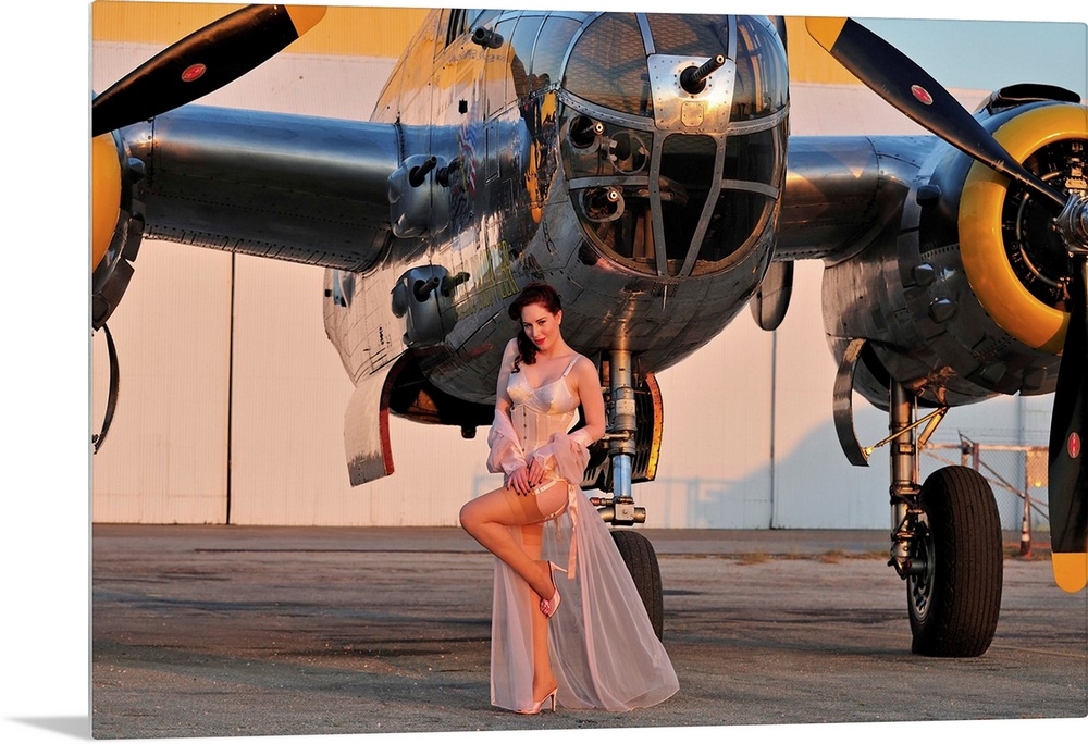 Sexy 1940's pin-up girl in lingerie posing with a B-25 bomber.