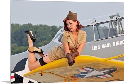 1940's style pin-up girl lying on a T-6 Texan training aircraft