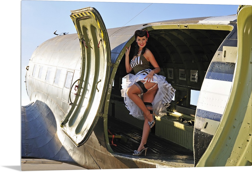 Sexy 1940's style pin-up girl with stockings, standing inside of a World War II C-47 Skytrain aircraft.