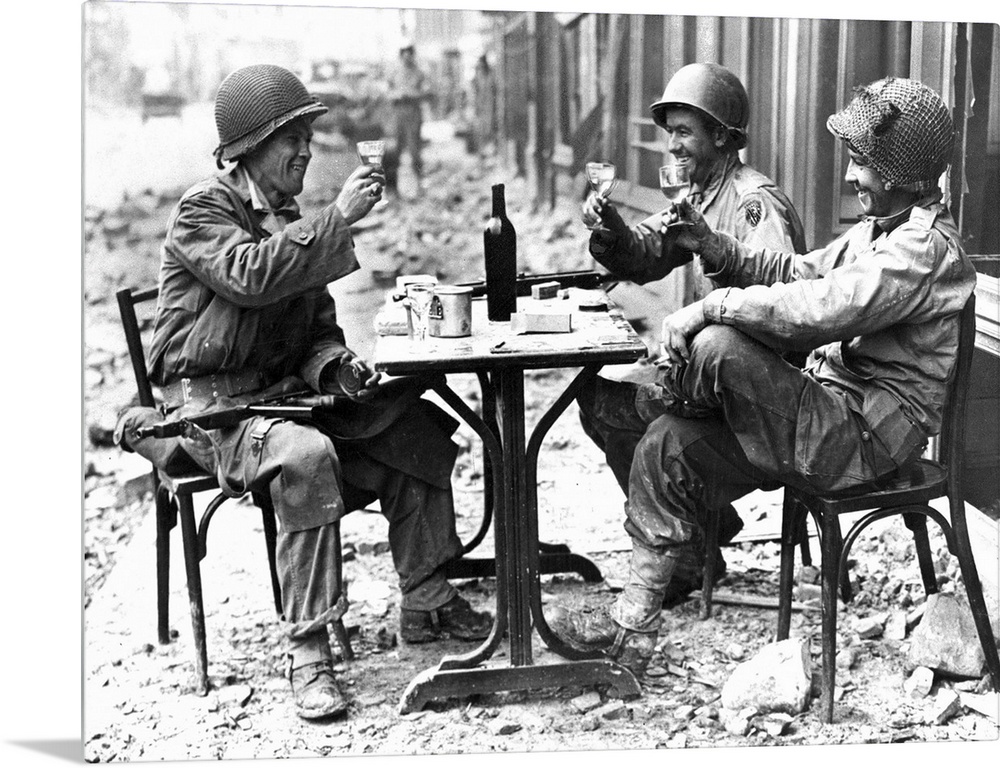 Three American soldiers at a sidewalk cafe in Paris, France, following the Allied liberation of the city, August 1944.