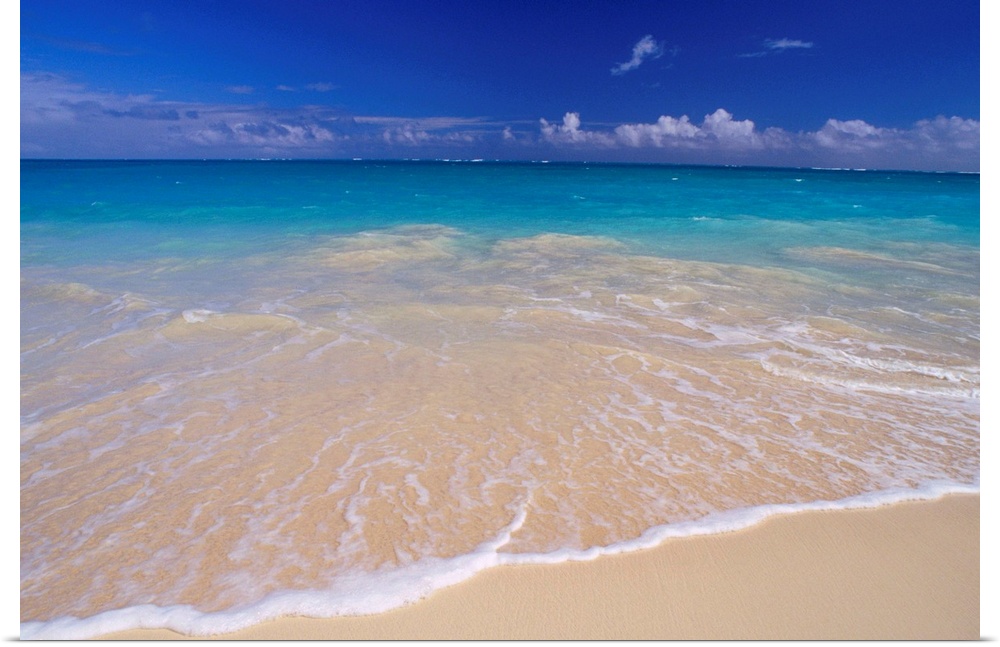 Wall docor of clear ocean water washing ashore a white sanded beach.