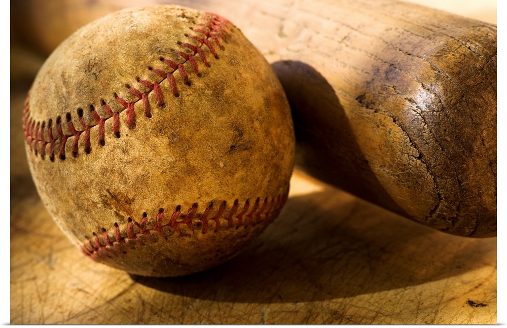 Distressed baseball and bat in this horizontal photograph.