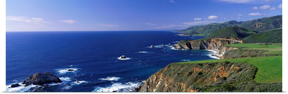 This wall art is a panoramic photograph of the coastal cliffs and the open ocean beyond.