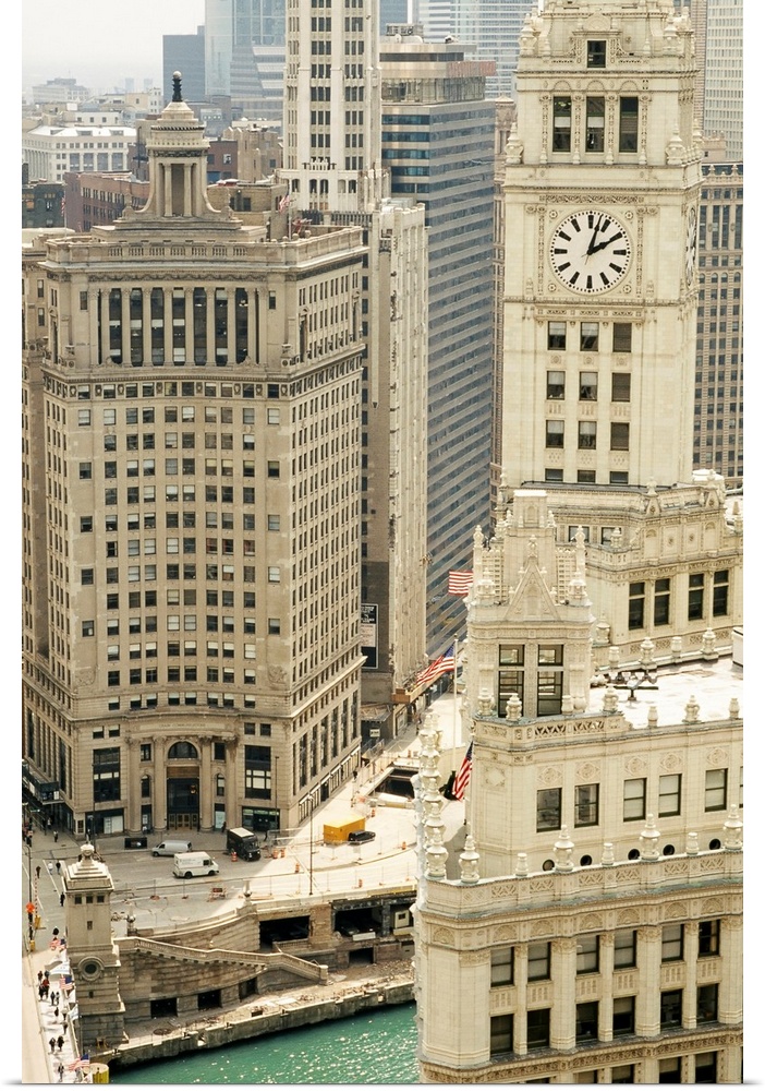 Big photograph includes an aerial view showing a variety of tall skyscrapers lining the waterway of a busy city within the...