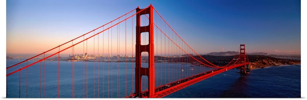 Big landscape photograph of the Golden Gate Bridge extending over the blue waters of the San Francisco Bay.