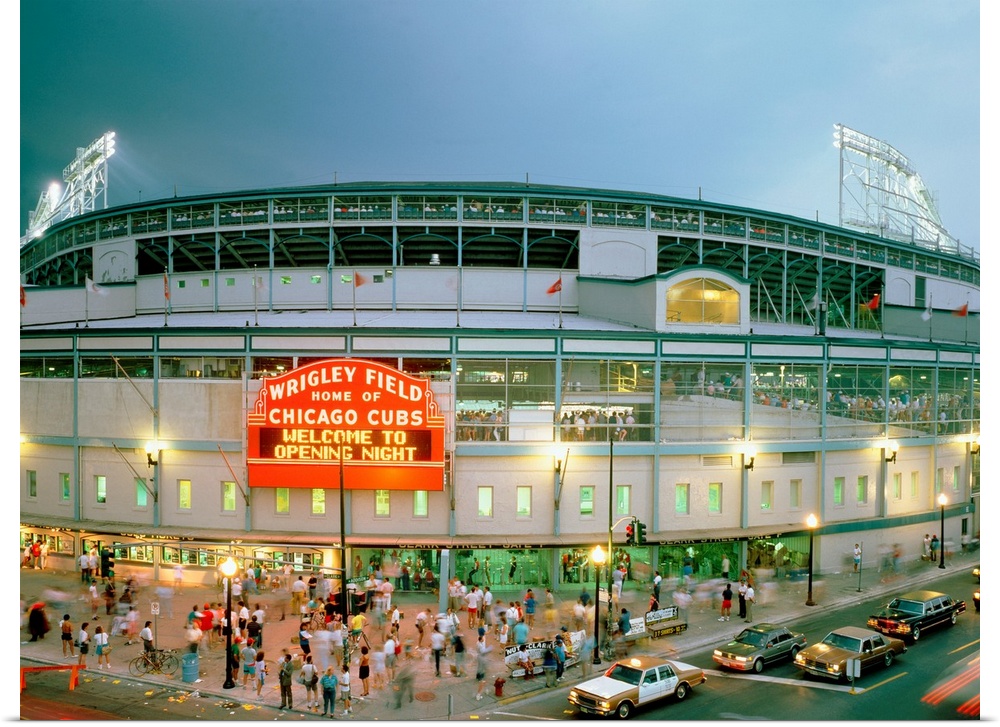 A horizontal photograph showing an entrance and sign to Chicagoos beloved baseball stadium.