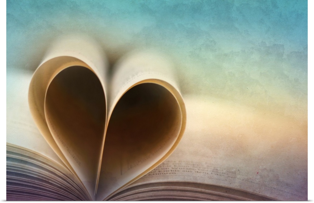 Vintage style rainbow photograph of an open book with the pages folded in the shape of a heart.