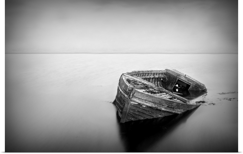 Long exposure of a abandoned boat in black and white.
