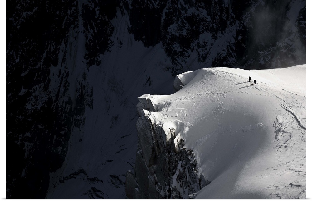 Mountain climbers near a treacherous cliff, Aiguille du Midi, Chamonix, France.
