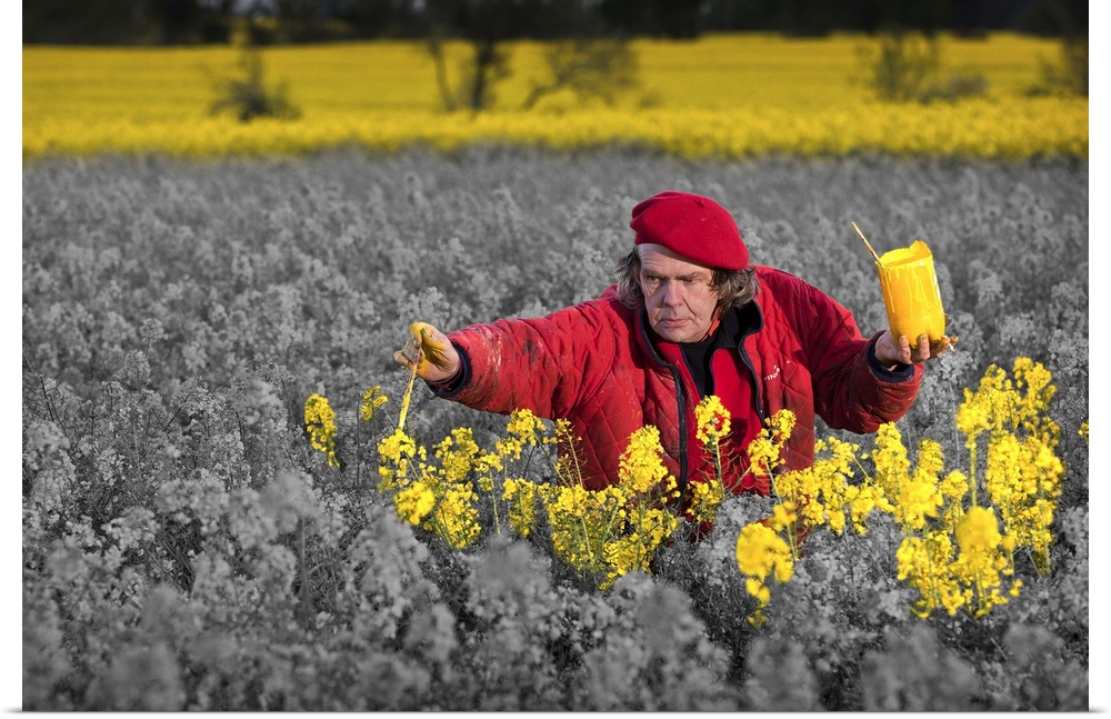 Conceptual image of an artist painting a field of flowers yellow.