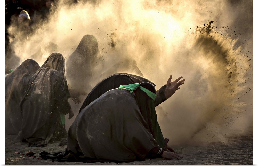 A group of people bending down and tossing dust into the air, iran.