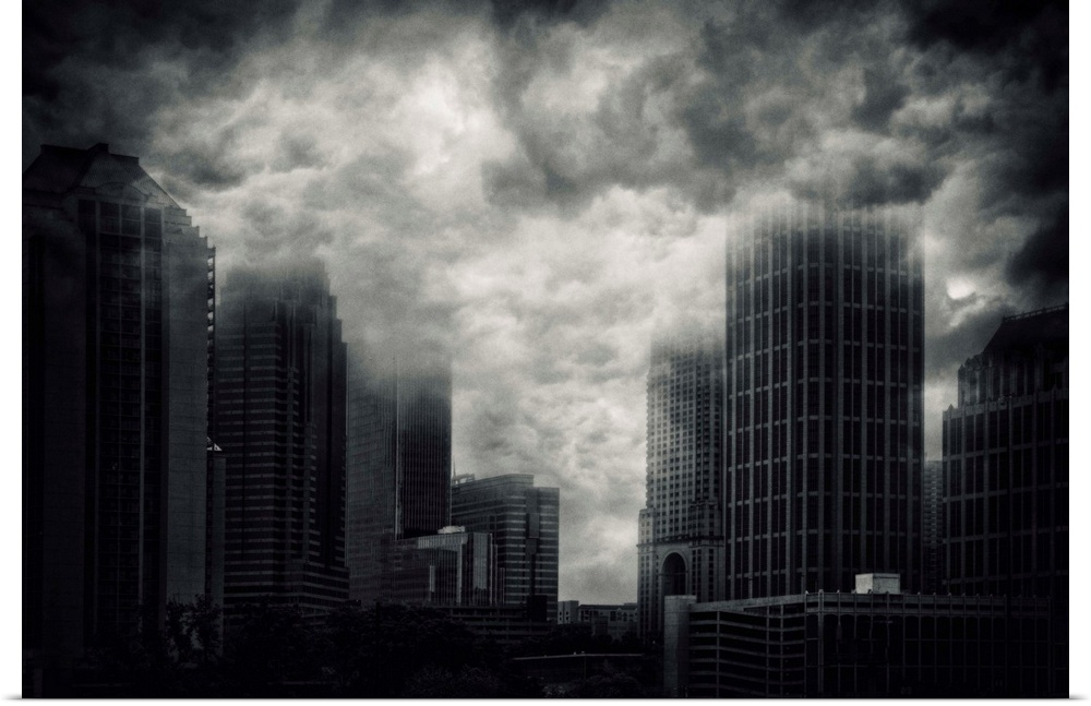 Conceptual image of storm clouds covering the tops of skyscrapers in Atlanta, Georgia.
