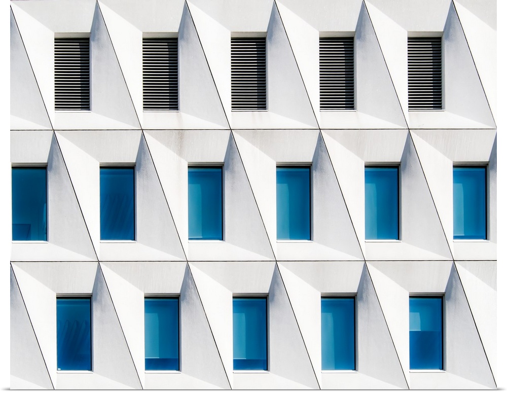Rows of windows and vents in a building, with diagonal lines.