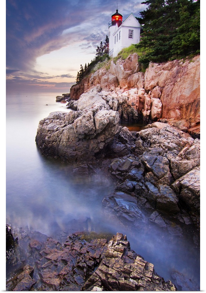 Bass Harbor Lighthouse on the edge of a rocky cliff on the coast of Acadia National Park, Maine.