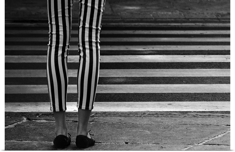 Black and white striped leggings perpendicular to the striped zebra crossing in the street.