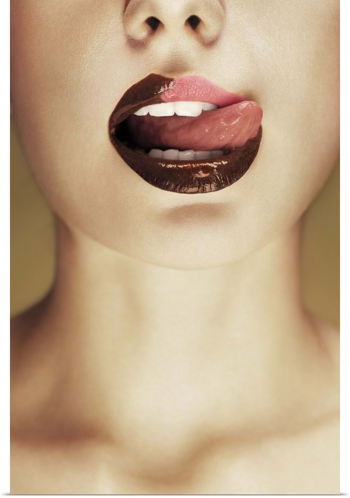A woman licking chocolate off of her lips with her tongue.