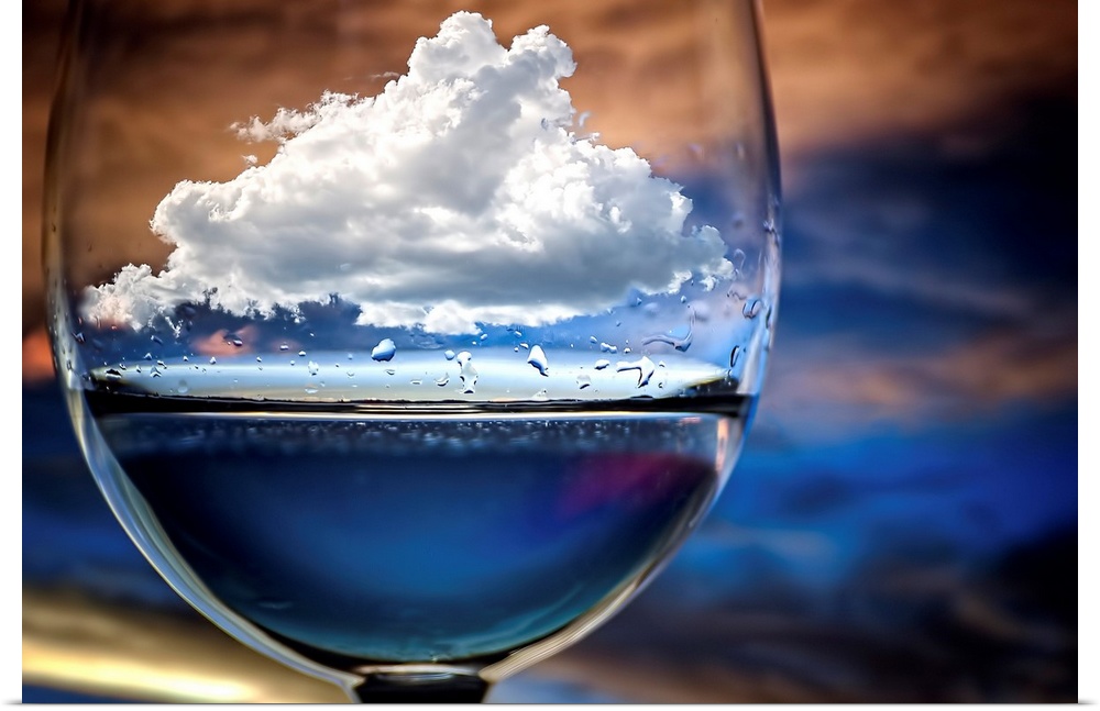 A conceptual photograph of a white fluffy cloud sitting suspended in a drinking glass, against a colorful background.