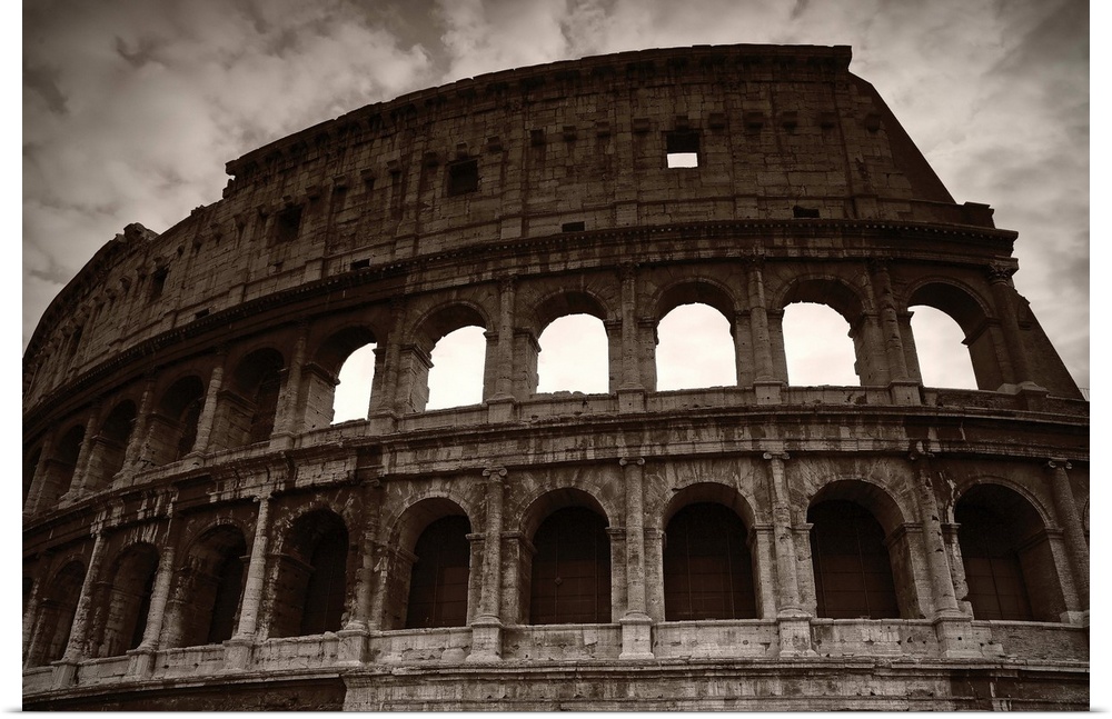 Sepia photograph of the Colosseum in Rome on a cloudy day.