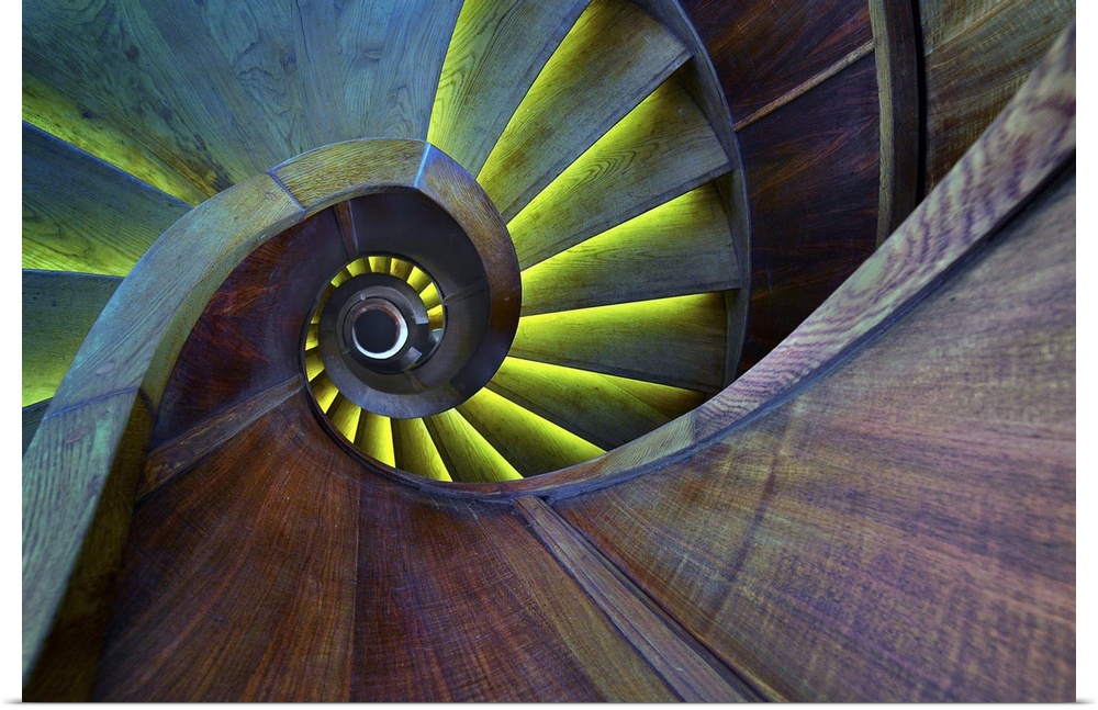 Spiral staircase with colorful lighting, creating an abstract image.