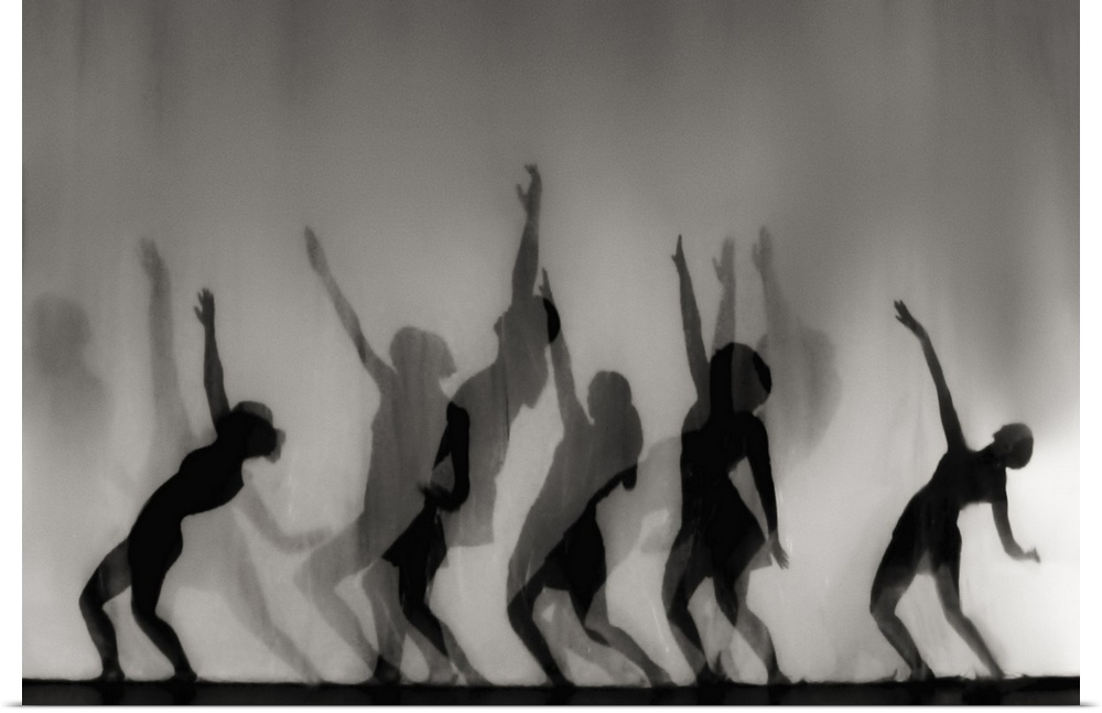 Silhouettes of female forms in dancing positions.