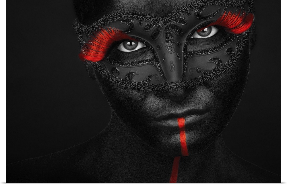 Portrait of a model with black body paint and bright red eyelashes.