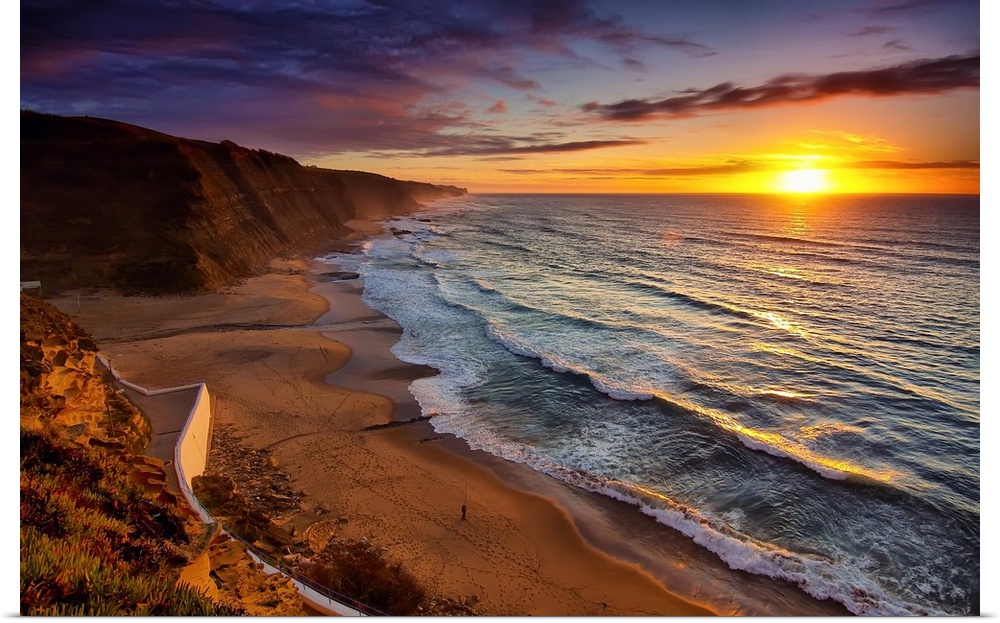 Warm landscape photograph of the sunset in Praia Do Magoito, Portugal.