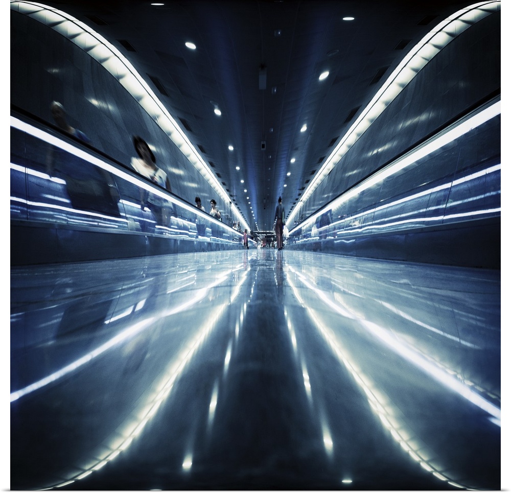 Reflective metal walkway with fluorescent lights, creating an abstract image. Barcelona Metropolitan Transport.