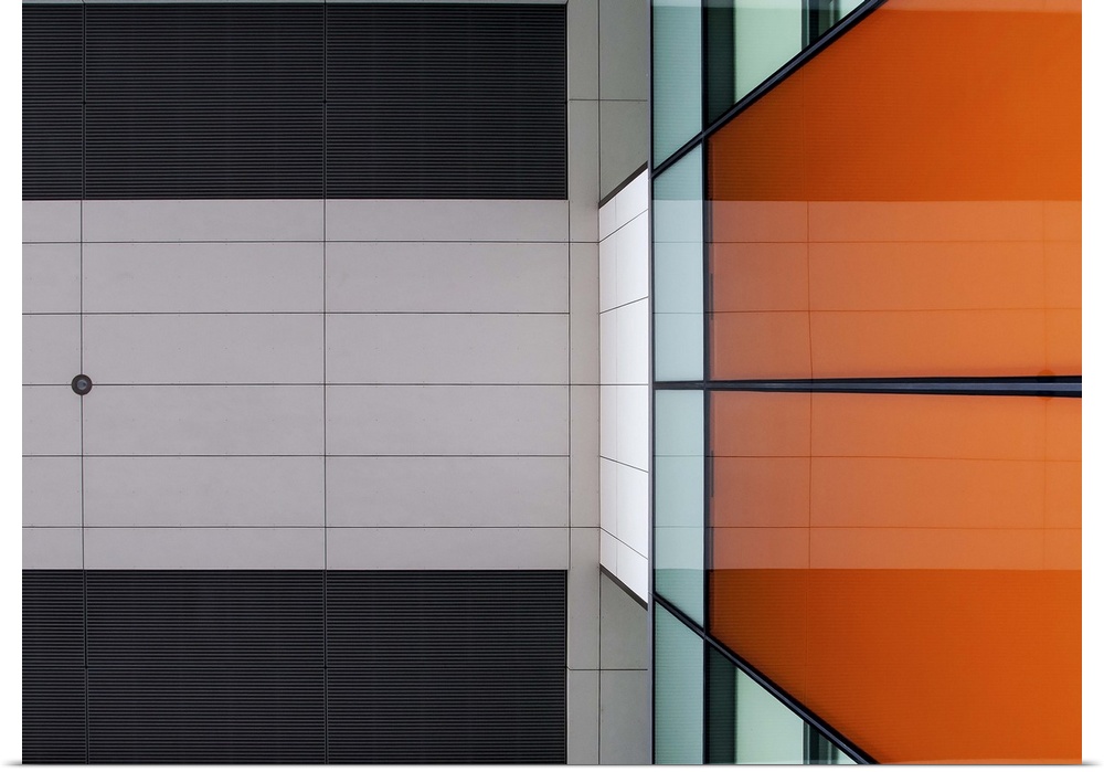 Orange glass and ceiling panels create an abstract image in Amsterdam.